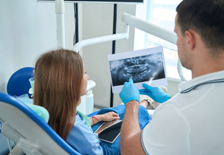 Dentist and patient reviewing X-ray together