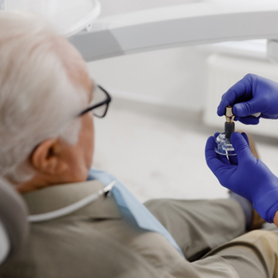 Dentist and senior patient discussing dental implants