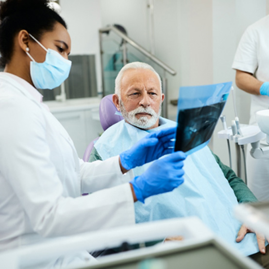 Dentist and patient looking at X-ray
