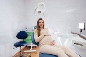 Pregnant patient in dental treatment chair 